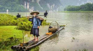 Cormorant fisherman and his birds on the Li River in Yangshuo, Guangxi, China.